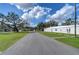 Road through community with trees and building at 5330 Vera St, Zephyrhills, FL 33542
