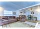 Open living room and dining area with leather sofas and seating at 5330 Vera St, Zephyrhills, FL 33542