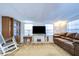 Living room with brown leather seating, large TV, and built-in shelving at 5330 Vera St, Zephyrhills, FL 33542