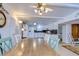 View from dining area shows kitchen with white cabinets and appliances at 5330 Vera St, Zephyrhills, FL 33542