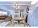 Bright dining area with wooden table and four chairs, view to living room at 5330 Vera St, Zephyrhills, FL 33542