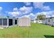 View of backyard with storage shed and green grass at 5330 Vera St, Zephyrhills, FL 33542