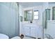 Clean bathroom with white vanity, shower, and mirror at 5330 Vera St, Zephyrhills, FL 33542