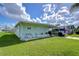 Mobile home exterior with covered carport and driveway at 5330 Vera St, Zephyrhills, FL 33542