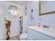 Clean bathroom with white vanity, and decorative mirror at 5330 Vera St, Zephyrhills, FL 33542