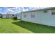 Side view of mobile home with storage shed and grassy yard at 5330 Vera St, Zephyrhills, FL 33542