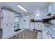 White kitchen with granite countertops, stainless steel appliances, and pantry at 5330 Vera St, Zephyrhills, FL 33542