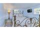 Cozy bedroom with a metal bed frame, floral bedding, and a TV at 5330 Vera St, Zephyrhills, FL 33542