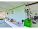 View of the light green mobile home and covered porch at 5330 Vera St, Zephyrhills, FL 33542