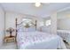 Bedroom with floral bedding, dresser, and ceiling fan at 5330 Vera St, Zephyrhills, FL 33542