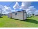 View of backyard with storage shed and green grass at 5330 Vera St, Zephyrhills, FL 33542