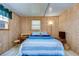 Bedroom with wood walls and a blue striped bed at 5330 Vera St, Zephyrhills, FL 33542