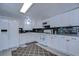 White kitchen with granite countertops and stainless steel appliances at 5330 Vera St, Zephyrhills, FL 33542