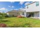 Home's backyard with grassy lawn and patio at 5625 Del Coronado Dr, Apollo Beach, FL 33572