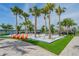 Charming sand play area with orange chairs and palm trees at 5625 Del Coronado Dr, Apollo Beach, FL 33572