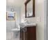 Simple bathroom with toilet, vanity, and marble tile at 7695 17Th N Way, St Petersburg, FL 33702