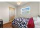 Cozy bedroom with double bed, wood flooring, and window at 7695 17Th N Way, St Petersburg, FL 33702