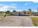 Ranch-style home with circular driveway and landscaping at 7695 17Th N Way, St Petersburg, FL 33702