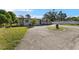 Front view of a ranch home with a large driveway at 7695 17Th N Way, St Petersburg, FL 33702