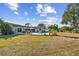 Expansive backyard featuring a pool, a spa, a patio, and lawn leading to the water, ideal for outdoor entertaining at 853 Seacrest Dr, Largo, FL 33771