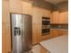 Modern kitchen with stainless steel appliances and light wood cabinets at 8900 143Rd St, Seminole, FL 33776