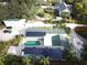 Aerial view showcasing home, pool, and large backyard with solar panels at 8900 143Rd St, Seminole, FL 33776
