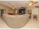 Spacious living room with a large sectional sofa, fireplace, and built-in shelving at 8900 143Rd St, Seminole, FL 33776