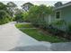 Side view of house with lush landscaping and driveway at 8900 143Rd St, Seminole, FL 33776