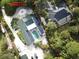Aerial view of property highlighting the house, pool, and surrounding landscape at 8900 143Rd St, Seminole, FL 33776