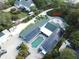 Aerial view of house, pool, and expansive backyard with solar panels at 8900 143Rd St, Seminole, FL 33776