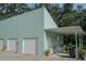 Three-car garage with covered carport and mature trees at 8900 143Rd St, Seminole, FL 33776