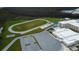 Aerial view of school campus with track and parking lot at 12902 Payton St, Odessa, FL 33556