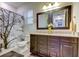 Double vanity bathroom with granite countertop and stylish mirrors at 12902 Payton St, Odessa, FL 33556