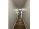 Long hallway with light walls and wood-look flooring at 2690 Coral Landings Blvd # 535, Palm Harbor, FL 34684