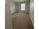 Spacious bedroom featuring neutral carpeting and a large window at 2690 Coral Landings Blvd # 535, Palm Harbor, FL 34684