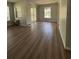 Bright living room with new flooring and sliding glass doors leading to a balcony at 2690 Coral Landings Blvd # 535, Palm Harbor, FL 34684
