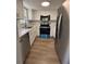 Modern kitchen with white cabinets, stainless steel appliances, and quartz countertops at 2690 Coral Landings Blvd # 535, Palm Harbor, FL 34684