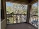 Private balcony overlooking trees and a parking lot at 2690 Coral Landings Blvd # 535, Palm Harbor, FL 34684