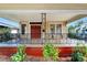 Charming home with a large front porch, featuring an ornate railing and landscaping at 2905 N 13Th St, Tampa, FL 33605