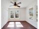 Bright bedroom with hardwood floors, ceiling fan, and large windows at 2905 N 13Th St, Tampa, FL 33605