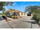 Charming yellow house with a front porch and driveway at 2905 N 13Th St, Tampa, FL 33605
