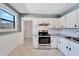 Updated kitchen with white cabinets, granite countertops, and stainless steel appliances at 2905 N 13Th St, Tampa, FL 33605