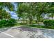 Courtyard with large tree and tennis court in background at 4144 56Th N St # 810, Kenneth City, FL 33709