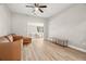 Living room with a brown leather sectional sofa and ceiling fan at 4363 5Th S Ave, St Petersburg, FL 33711