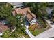 Aerial view showcases a luxury home with mature trees, an inviting driveway, and meticulous landscaping at 4633 W Lowell Ave, Tampa, FL 33629