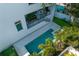 Aerial view of a house with a covered patio overlooking the pool and palm trees at 4633 W Lowell Ave, Tampa, FL 33629