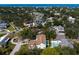 A captivating aerial view captures a charming home surrounded by lush greenery with neighborhood views at 4633 W Lowell Ave, Tampa, FL 33629