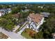 Aerial view of an elegant home with a manicured lawn in a lush, green neighborhood at 4633 W Lowell Ave, Tampa, FL 33629