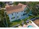 Aerial view of the backyard featuring a pool, lush lawn, and modern home design at 4633 W Lowell Ave, Tampa, FL 33629