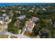 Aerial view captures a beautiful home surrounded by lush landscaping, a serene pond, and neighborhood charm at 4633 W Lowell Ave, Tampa, FL 33629